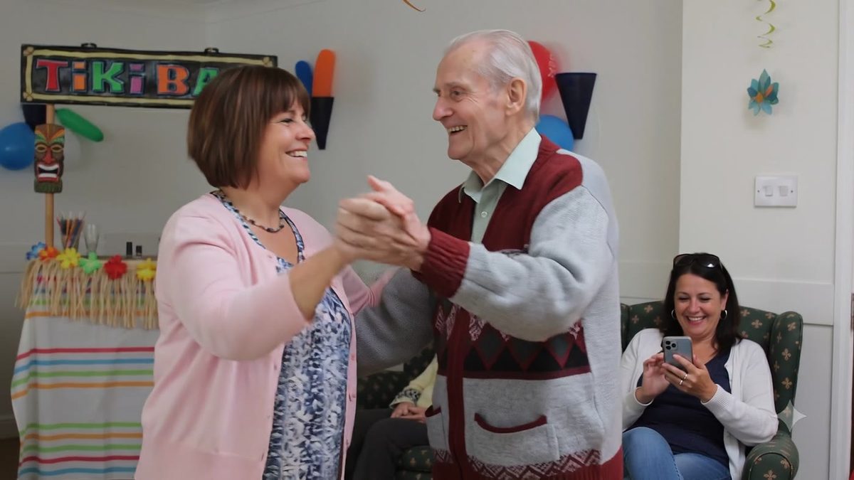 Dancing with a resident at a party in the lounge